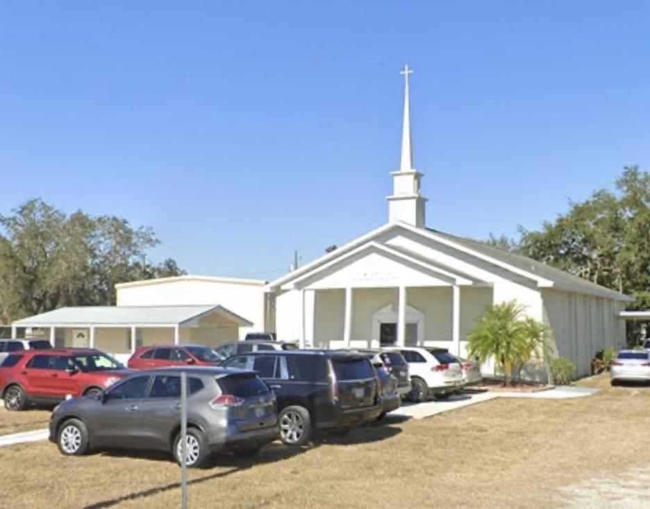 The front of Lake Region Baptist Church with its white columns and steeple